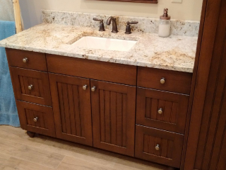 Stained vanity with granite countertop